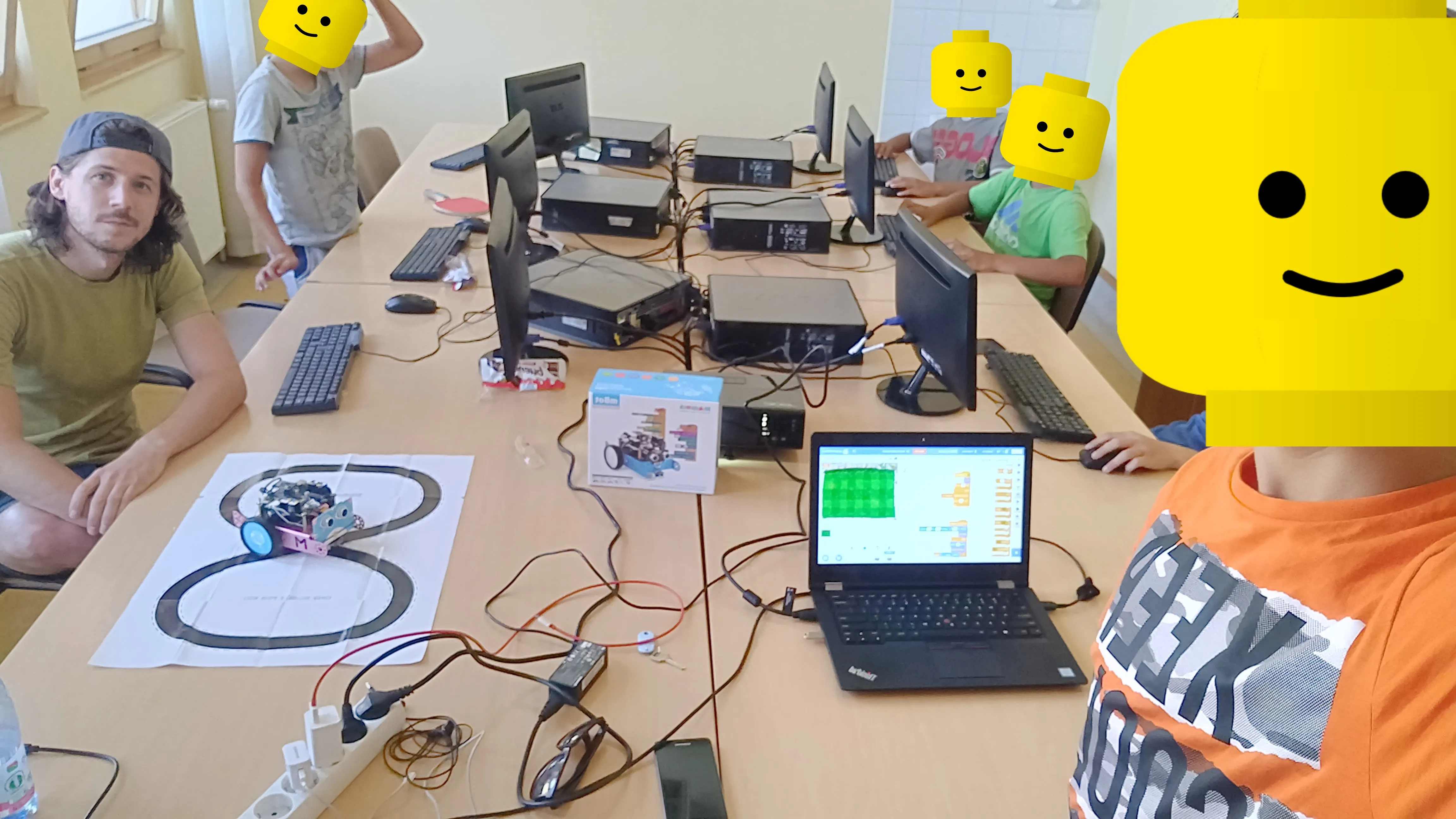 Programming camp: laptops, robots and kids around a table